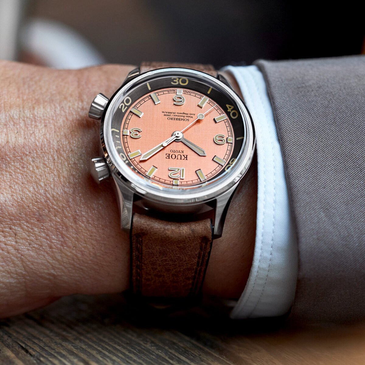 KUOE SOMBRERO 90-011 Salmon Pink linen textured dial Miyota 9039 20 BAR with leather strap on wrist